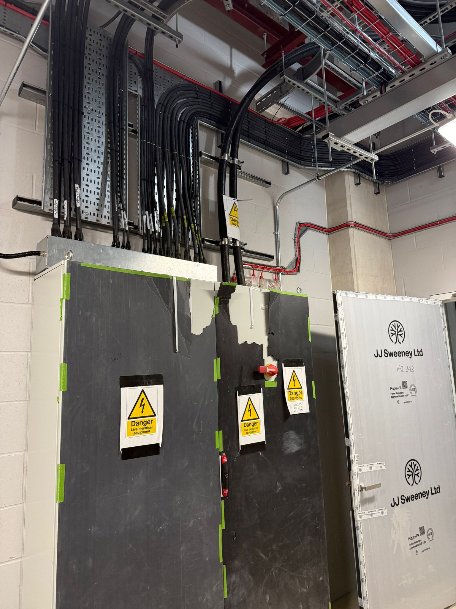 Main control panels with heavy cable bundles from cable basket